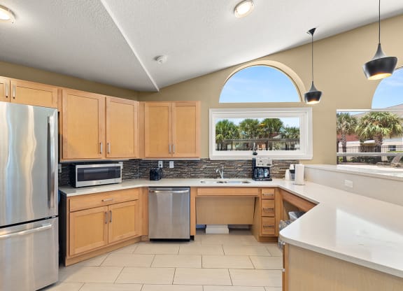 a kitchen with wooden cabinets and stainless steel appliances