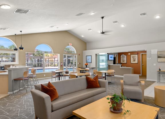 a living room with couches and chairs and a table with chairs