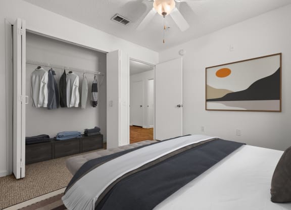 a bedroom with a large bed and a closet