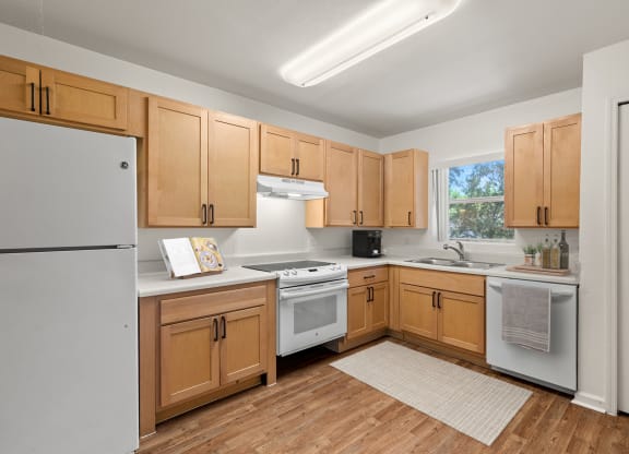 a kitchen with wooden cabinets and white appliances