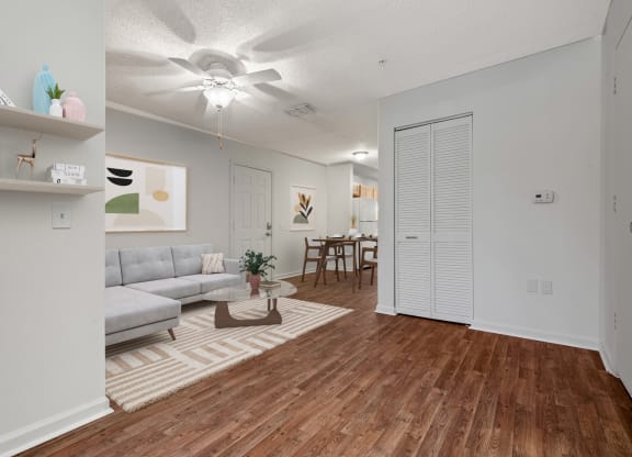 an open living room and dining room with a ceiling fan