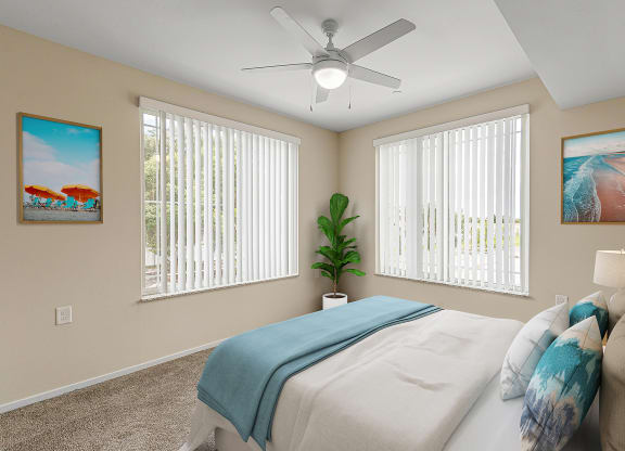 Bedroom with cozy bed and ceiling fan at Sandpiper Glen 62+ Apartments, Florida