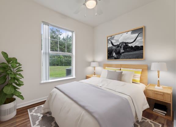 Bedroom area with cozy bed at Sandy Creek Apartments, Bryan, Texas