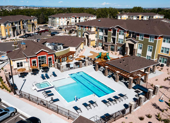 an aerial view of an apartment complex with a swimming pool