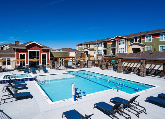 our apartments have a large swimming pool with chairs and tables