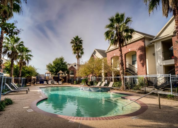 Pool with palm trees at Villa Springs, Houston, TX, 77090