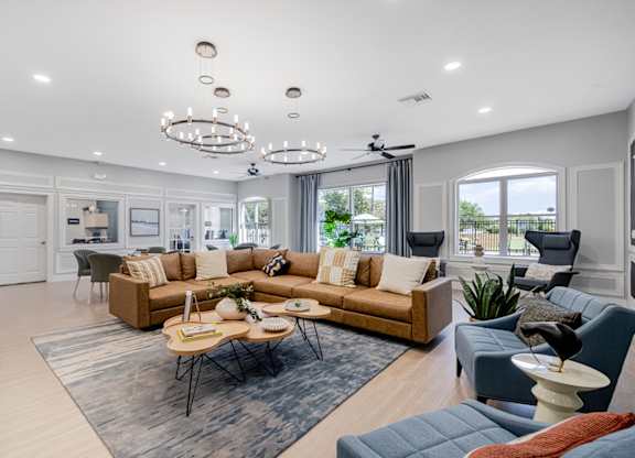 A spacious living room with a large sectional sofa and a coffee table in the center.