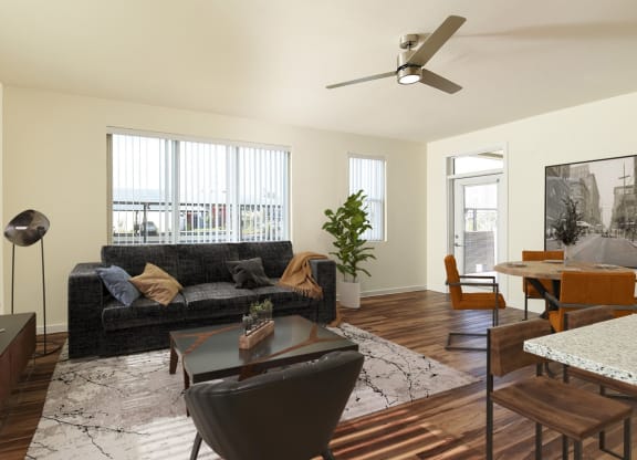 a living room with a couch and a table and a ceiling fan at Casa Azure 55+ Apartments, Phoenix, 85035