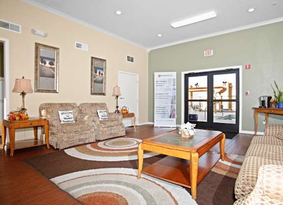 A living room with a couch, chair, and coffee table.