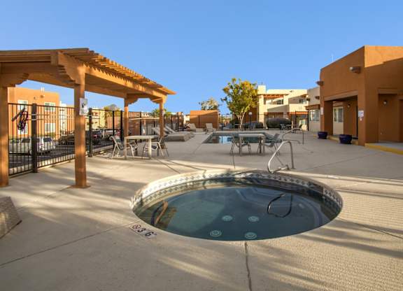 A hot tub sits in the middle of a patio area.