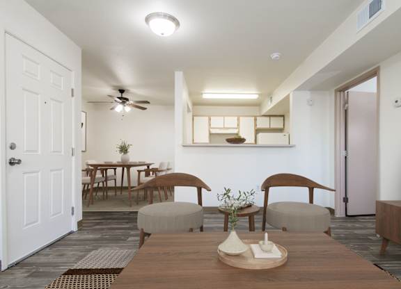 A modern dining room with a wooden table and chairs.