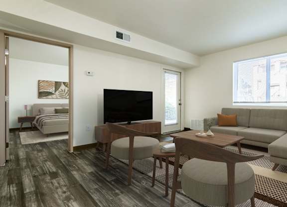 A living room with a grey couch and a wooden table.