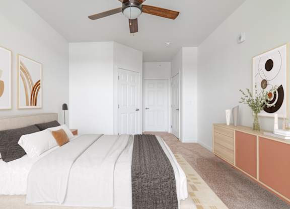 A bedroom with a large bed and a ceiling fan.