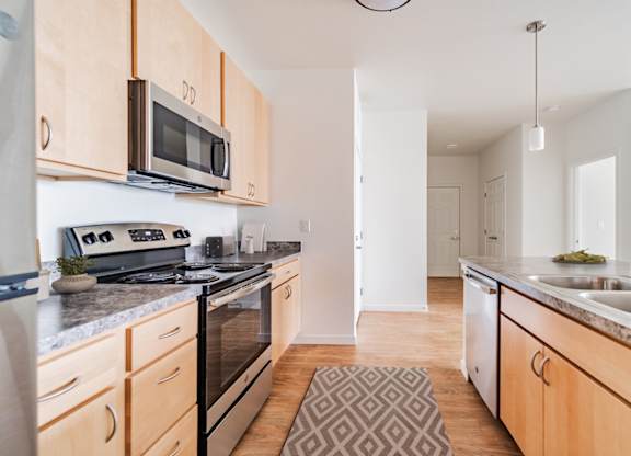 A kitchen with wooden cabinets and a granite countertop.