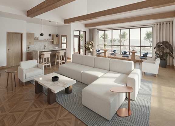 A modern living room with a large white sofa and a coffee table.