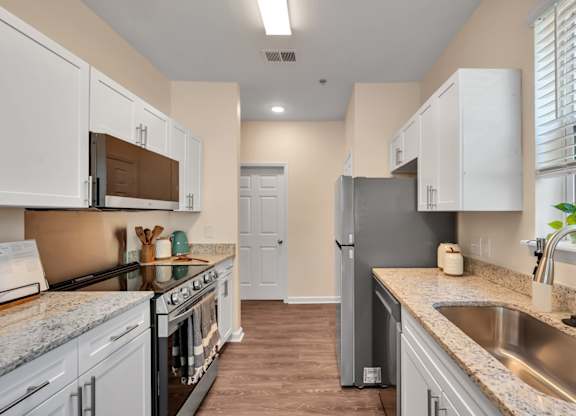 A kitchen with a stove, oven, and refrigerator.