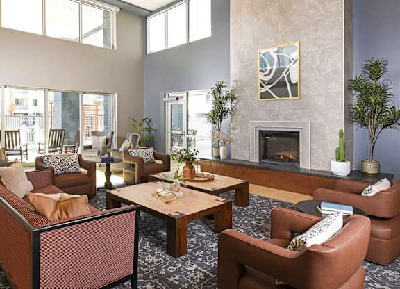 A living room with a fireplace and a painting on the wall.