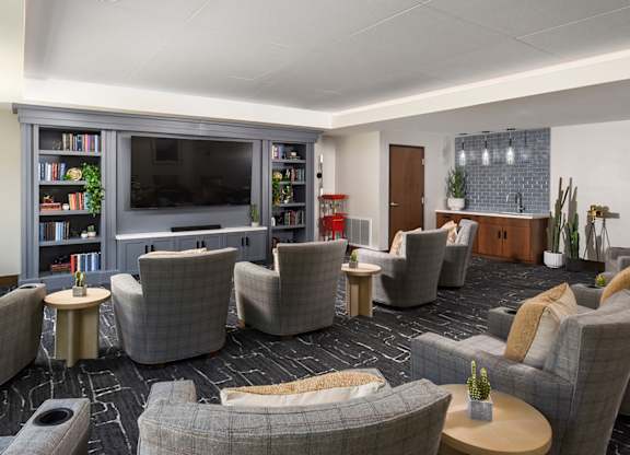 A living room with grey couches and a television.