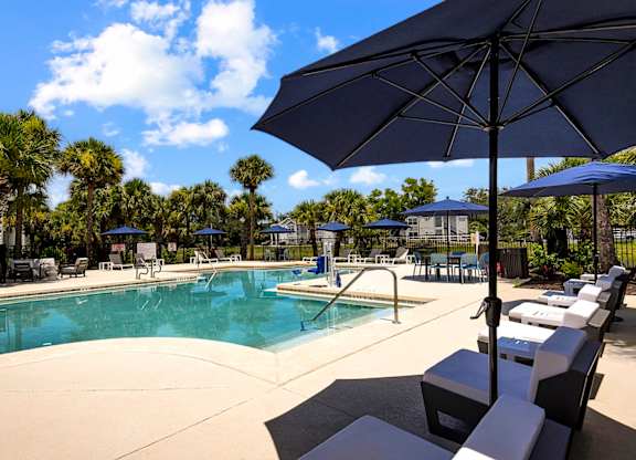 Pool With Relaxing Chairs at The Lucille Apartments, Stuart, 34996