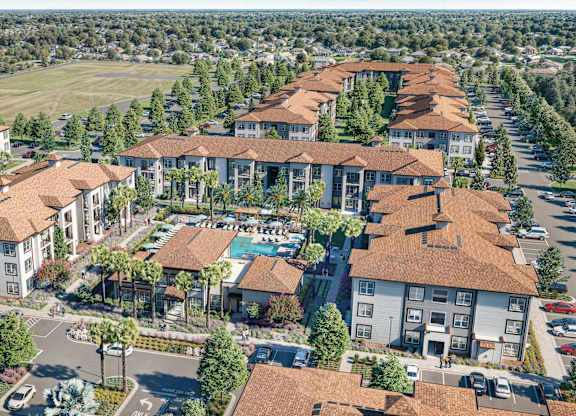 A large, well-maintained apartment complex with a pool and landscaping at Maison at Solivita Marketplace Apartment Homes, Kissimmee, 34758