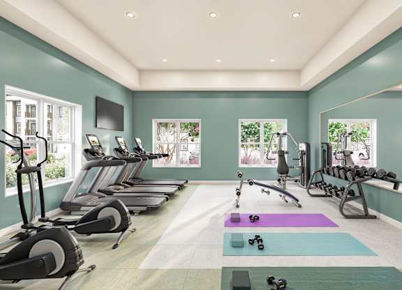 A well-lit gym with treadmills, exercise bikes, and dumbbells at Maison at Solivita Marketplace Apartment Homes, Kissimmee, FL, 34758