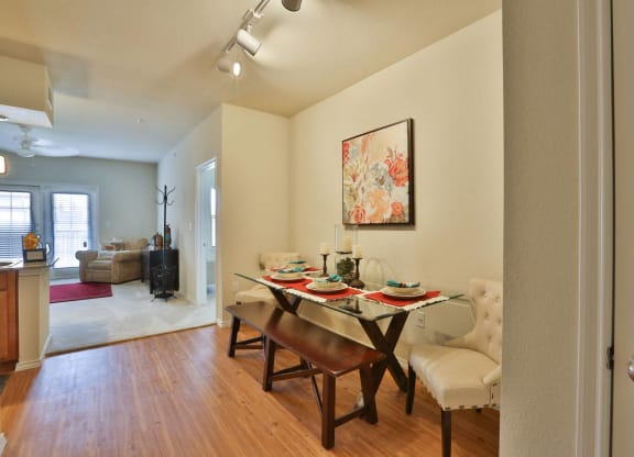 a dining room with a table and chairs and a living room at Cedars of Elk Drive 55+ Apartments, Burleson, 76028