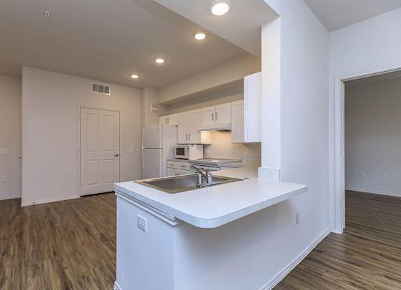 a kitchen with white cabinets and a sink at Mariposa at Westchester, TX 75052