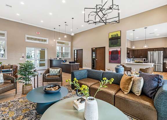 A living room with a brown couch and a coffee table.
