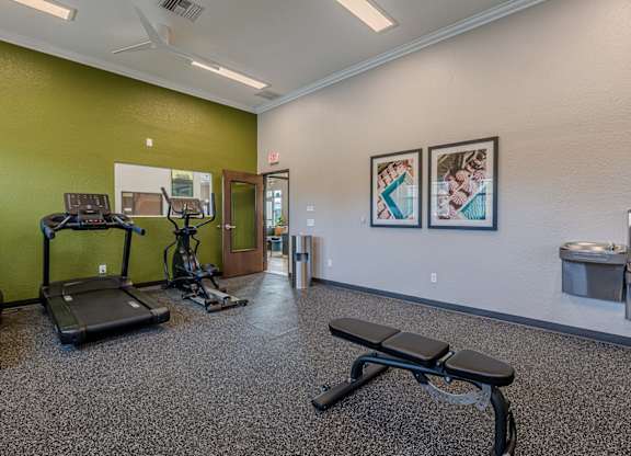 A gym with treadmills, exercise bikes, and other equipment.