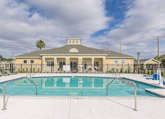 A large building with a pool in front of it.