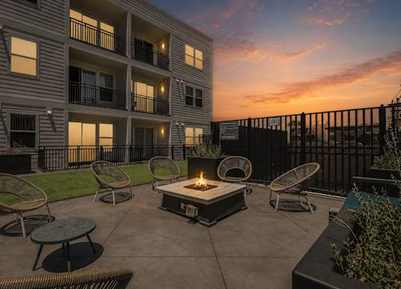 Dominium_Park Avenue West_Patio Firepit Dusk w firepit lit