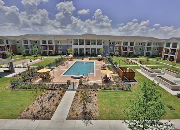 an aerial view of the resort style pool at the residences at town center apartments