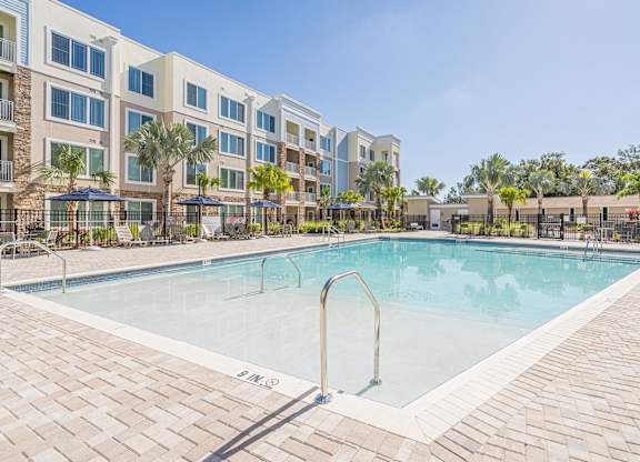Swimming pool view with patio at Sandpiper Glen 62+ Apartments, Orlando, FL, 32825