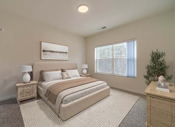 A bedroom with a large bed, a nightstand with a lamp, and a framed picture on the wall.