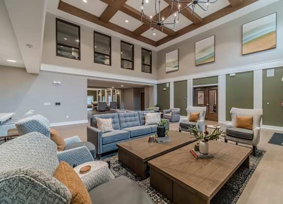 A living room with a blue couch and a wooden coffee table.