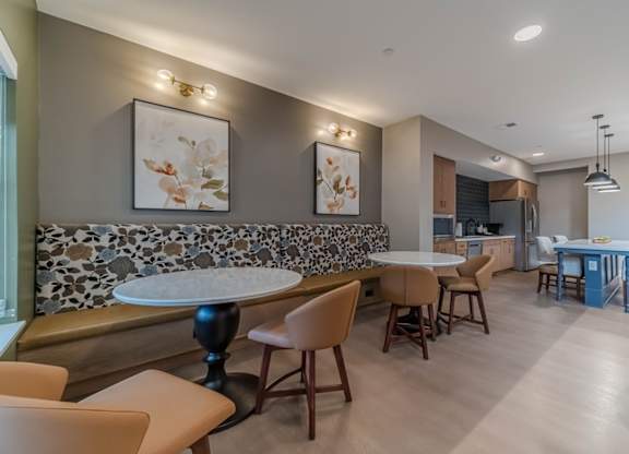 A modern dining room with a stone backsplash and wooden furniture.