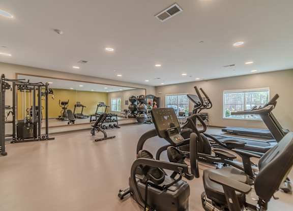 A spacious gym with a variety of exercise equipment.