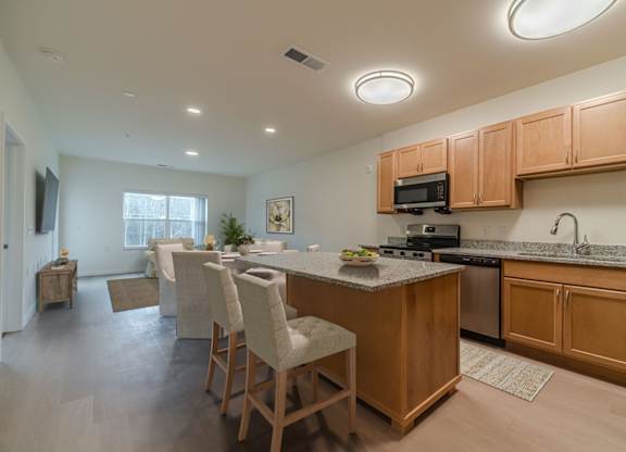 A kitchen with wooden cabinets and a granite countertop.
