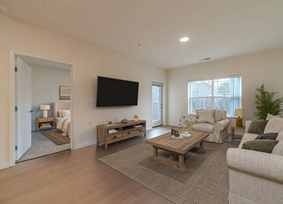A living room with a flat screen TV mounted on the wall.