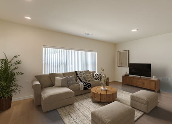 A living room with a couch, coffee table, and television.