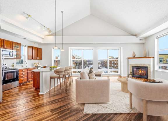 A modern kitchen with a dining area and a fireplace.