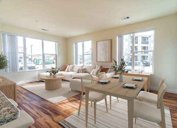 A dining room with a wooden table and chairs.