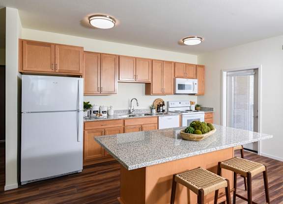 A Kitchen with Refrigerator at Suncrest Vista at Canyon Trails 55+ Apartments, Arizona, 85338