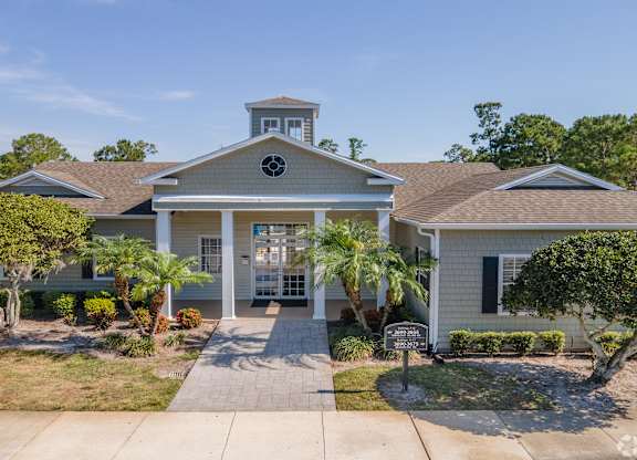 A house with a front yard and a driveway.
