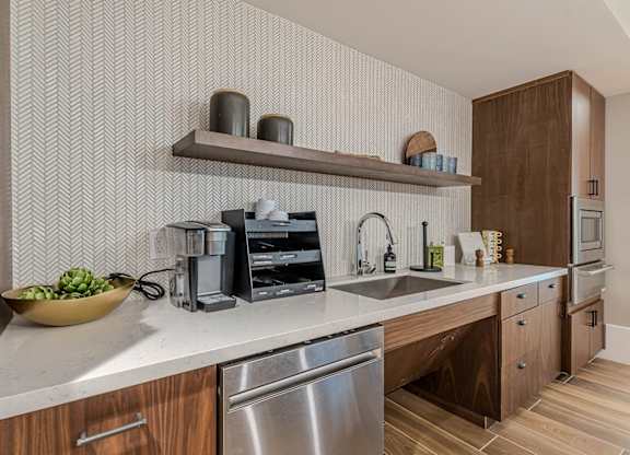 a kitchen with wooden cabinets and a sink at Willow Place 55+ Apartments, McDonough, Georgia