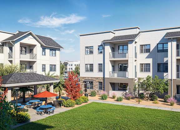 A sunny day at a residential complex with a gazebo and trees at Arterra Apartment , Surprise