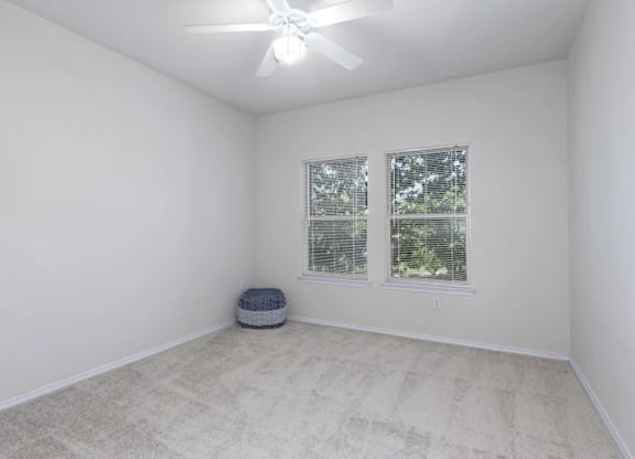 a white room with two windows and a ceiling fan at Mariposa at Bay Colony, Dickinson, TX 77539