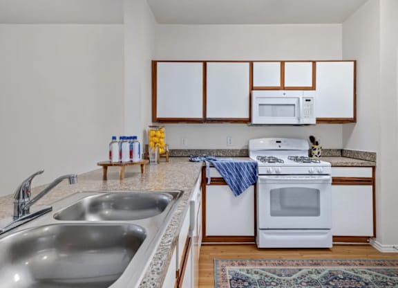 a kitchen with a sink and a stove and a microwave at Mariposa at Bay Colony, Dickinson Texas