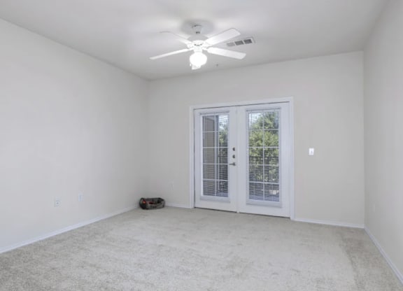 an empty living room with a ceiling fan and a window at Mariposa at Bay Colony, Texas, 77539