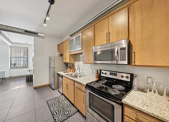 Kitchen with stove top oven at Arcade Apartments, St Louis, Missouri